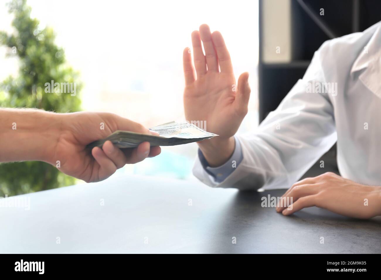 Doctor refusing to take bribe from patient at workplace Stock Photo Alamy