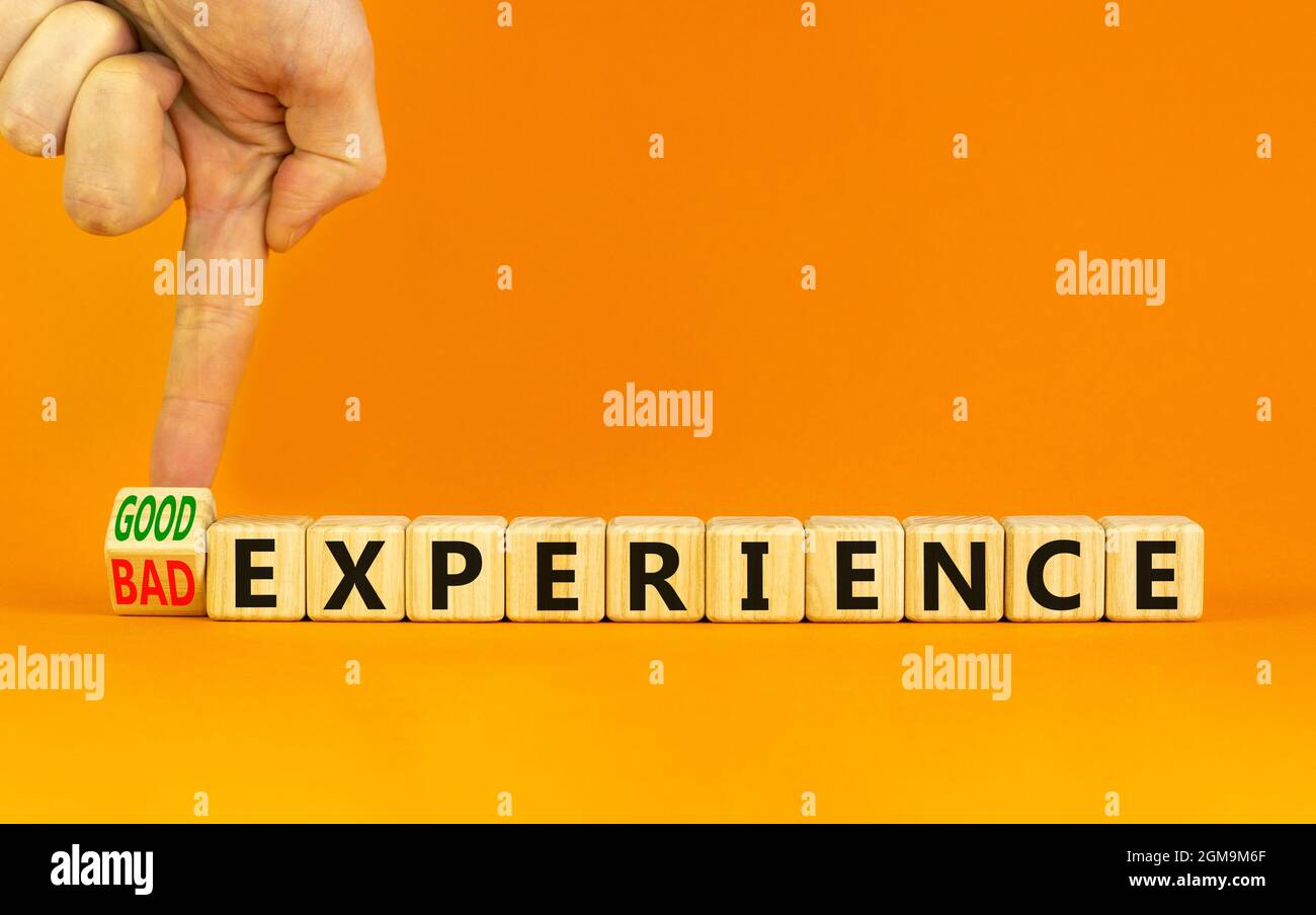 Good or bad experience symbol. Businessman turns a wooden cube, changes ...