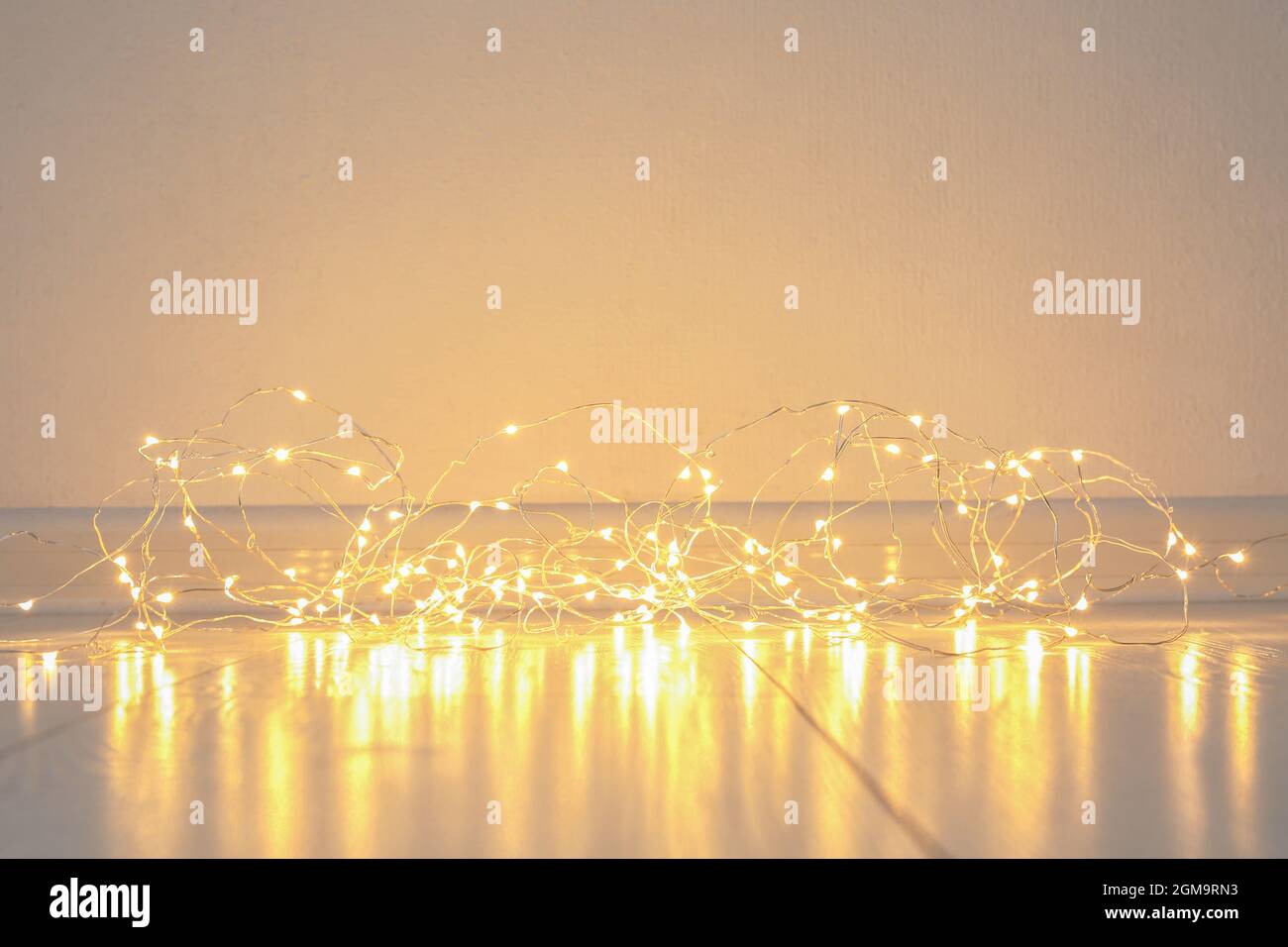 Glowing Christmas lights on floor Stock Photo Alamy