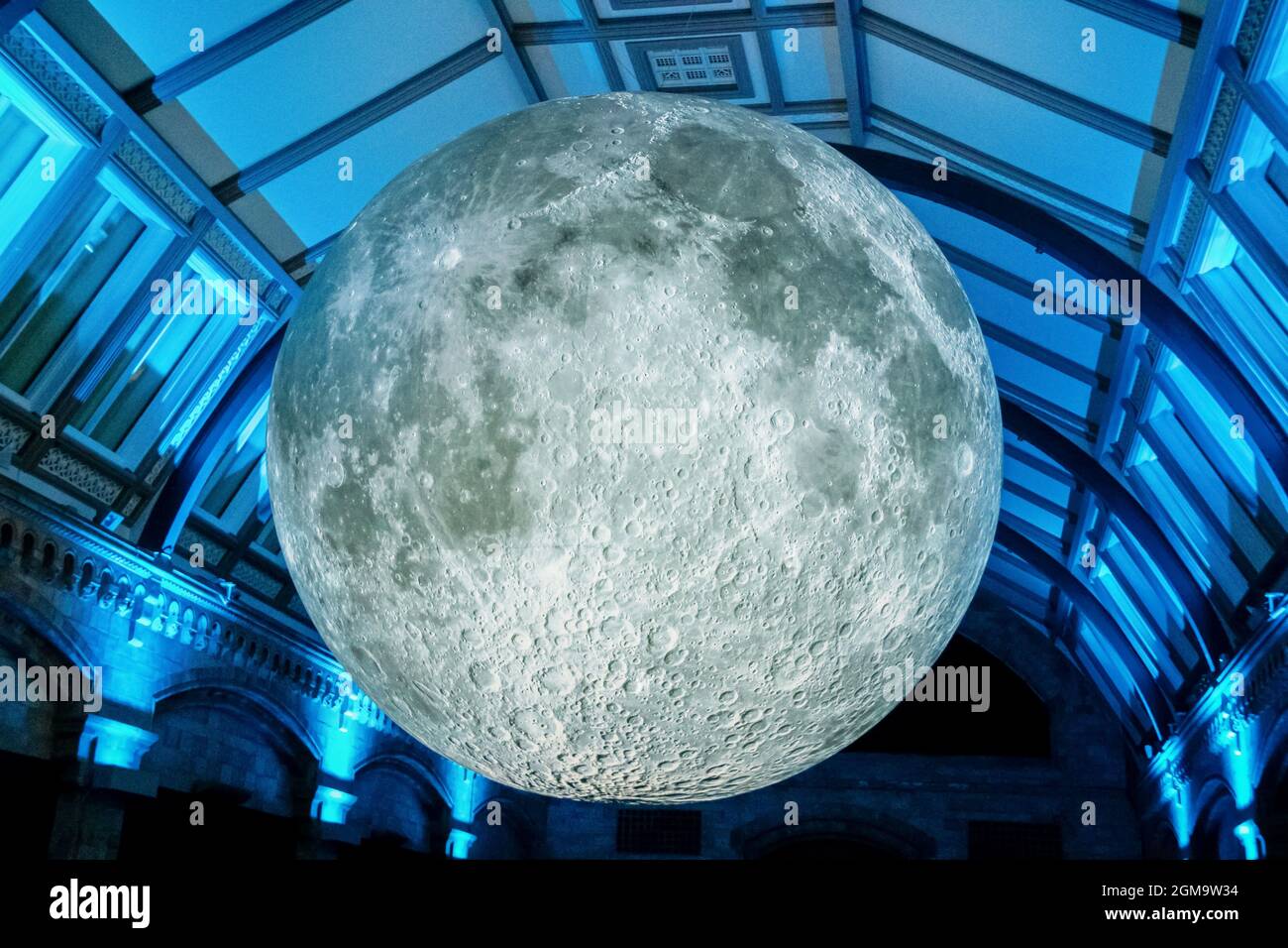 7-26-2019 London UK -3-D model of the moon displayed in free-to-public Natural Science Museum - hanging from ceiling with dramatic lighting Stock Photo