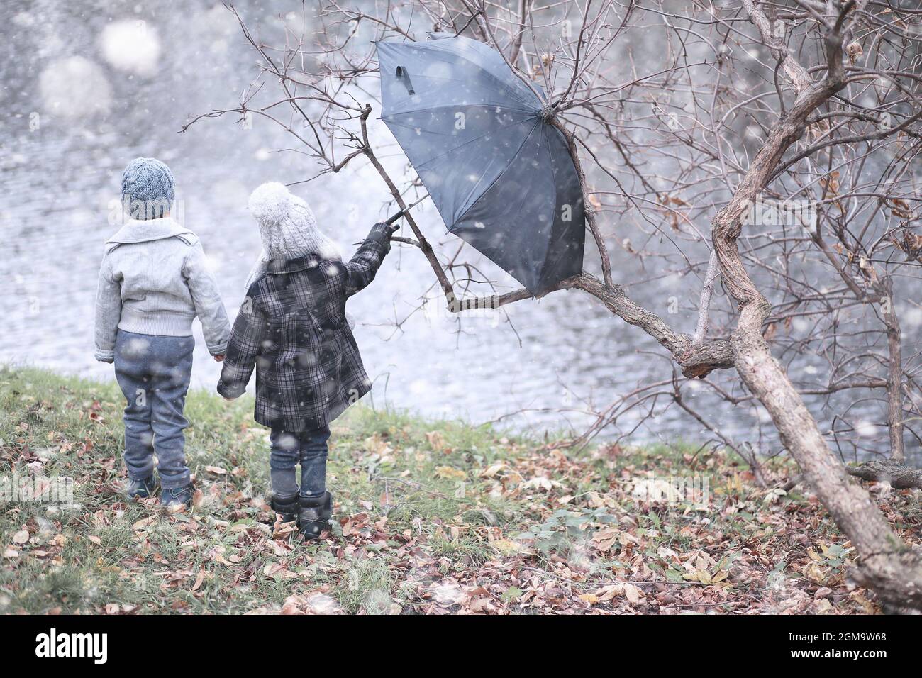 Kids walk in the park with first snow Stock Photo - Alamy