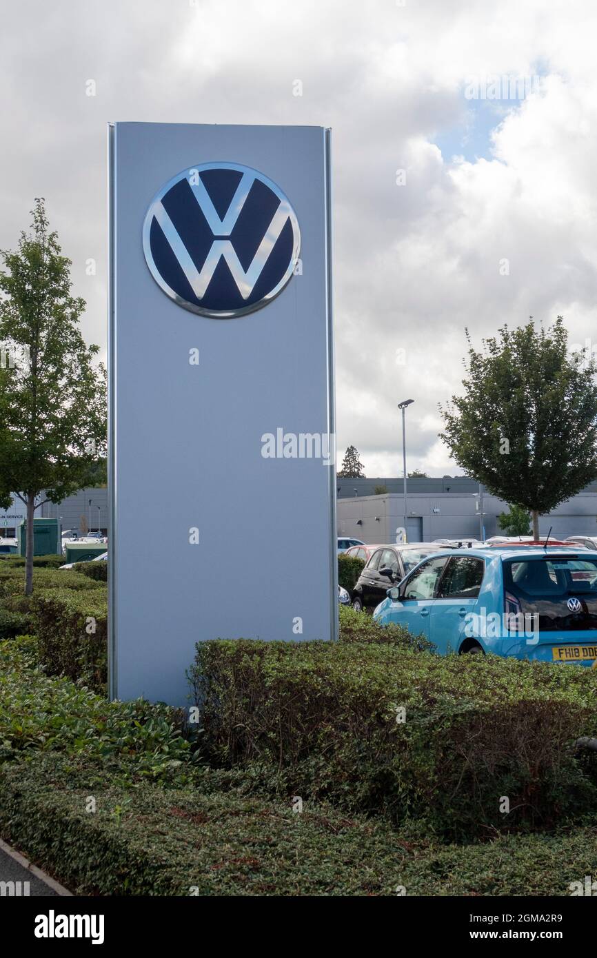 VW Volkswagen car logo and sign outside Inchcape car dealer showroom