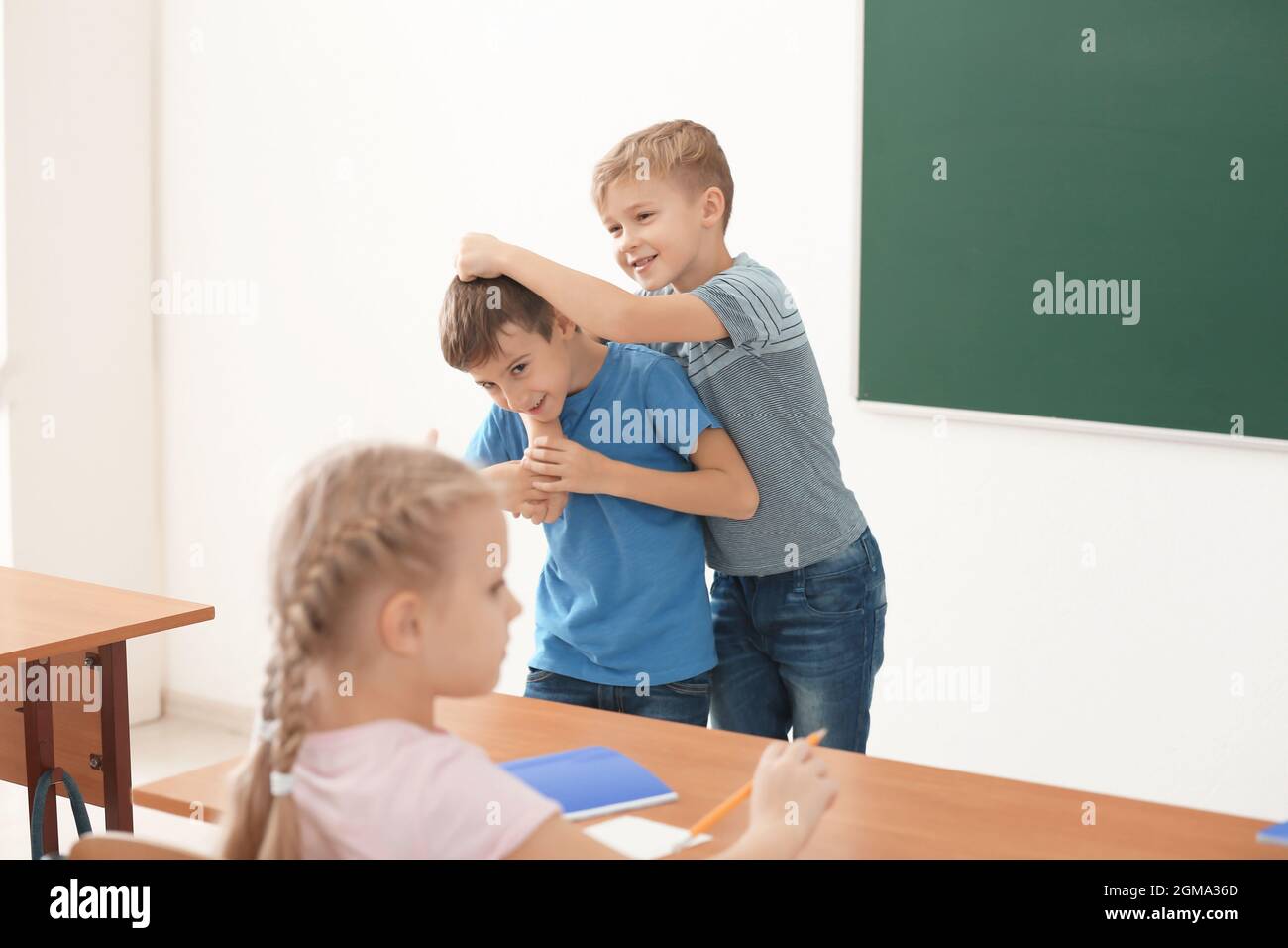 Little boy bullying his classmate in school Stock Photo - Alamy