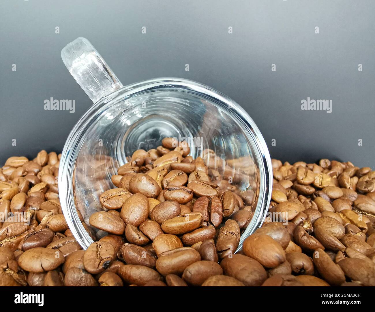 Closeup of a cup of coffee with roasted dark brown coffee beans Stock Photo