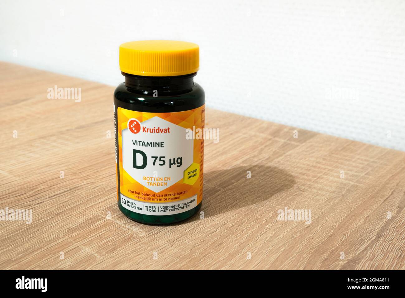 Bottle of vitamine D capsules from the brand Kruidvat on a table Stock Photo