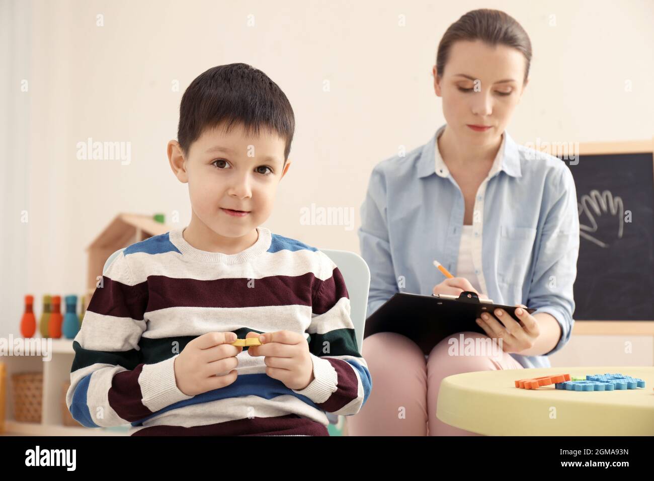 Little boy with autistic disorder at child psychologist's office Stock