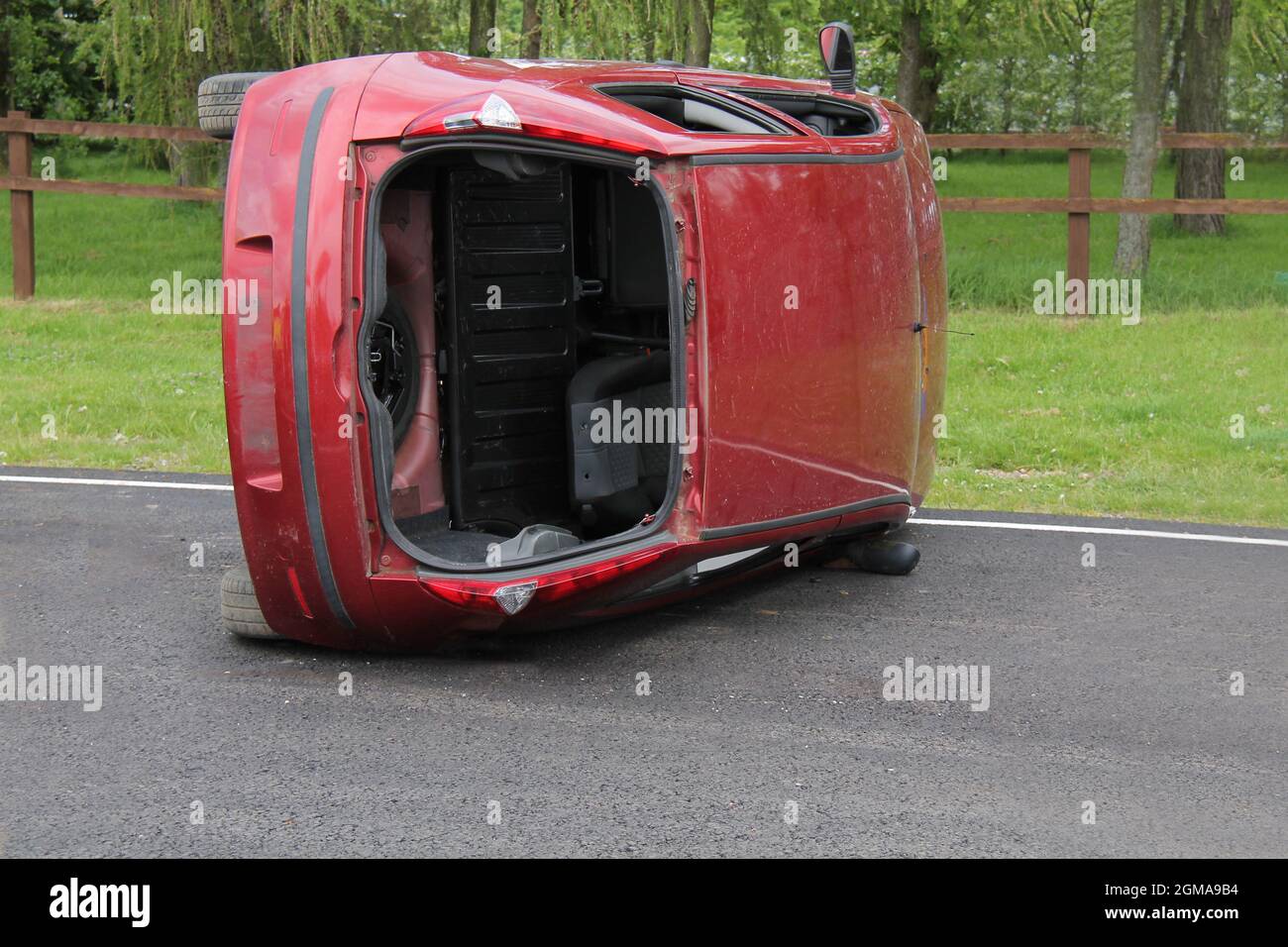 A Smashed Car Accident Wreck on its Side. Stock Photo