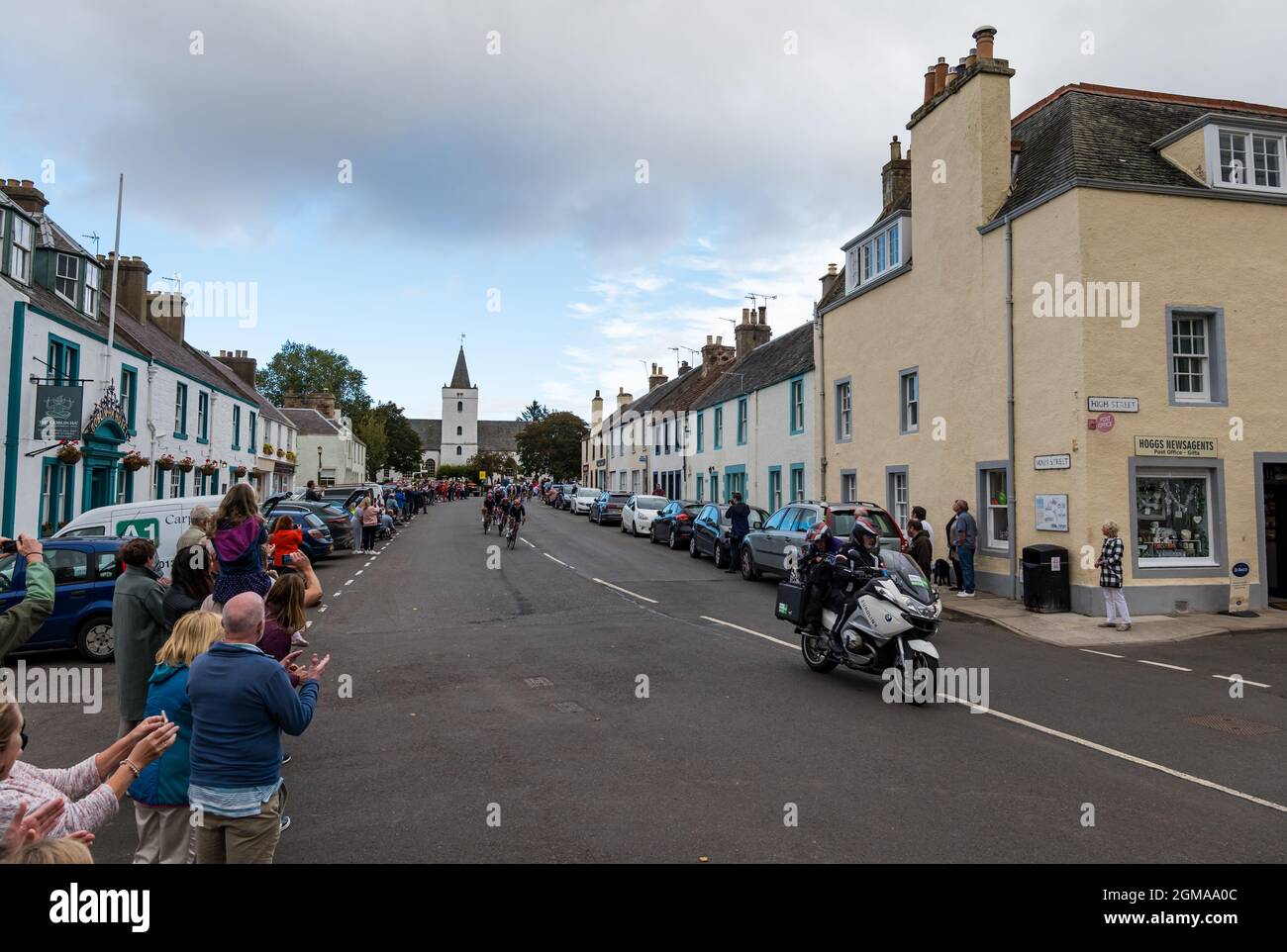 A J Bell Tour of Britain cycling race peleton passes through Gifford village, East Lothian, Scotland, Uk Stock Photo