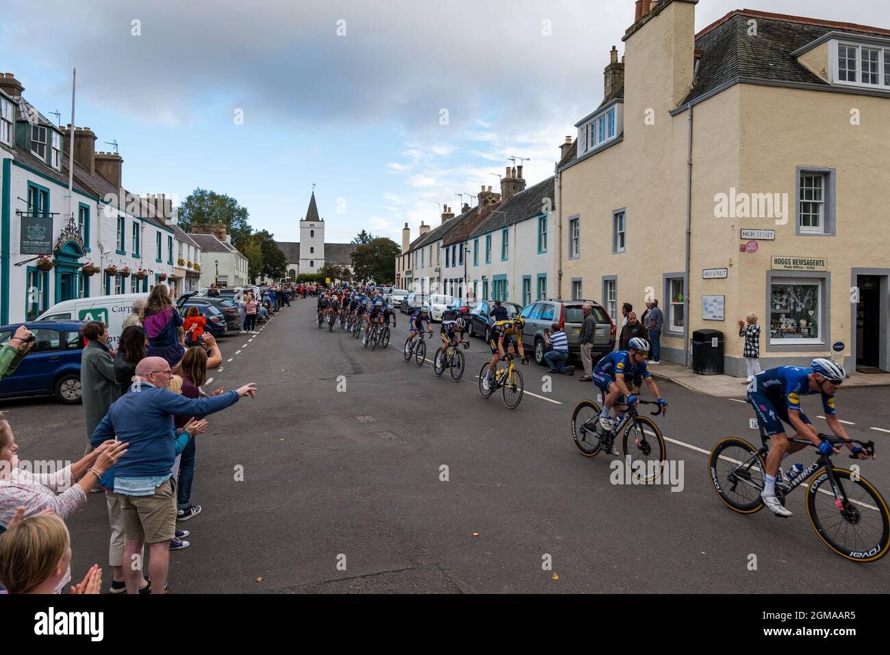 A J Bell Tour of Britain cycling race peleton passes through Gifford village, East Lothian, Scotland, Uk Stock Photo