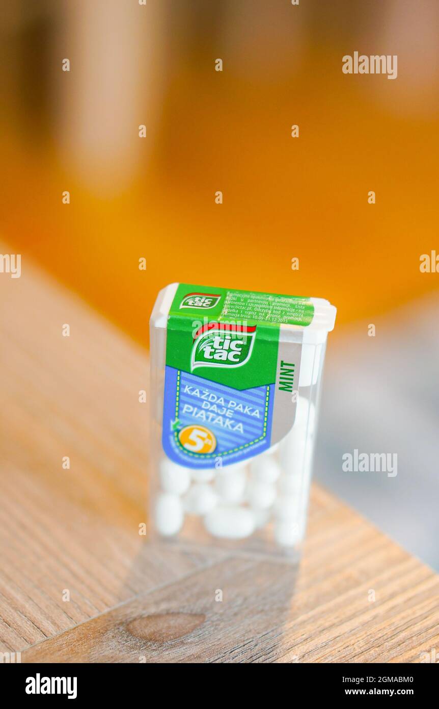 POZNAN, POLAND - Apr 13, 2016: A closeup of the mint-flavored tic tac candies in the plastic container on the wooden table Stock Photo
