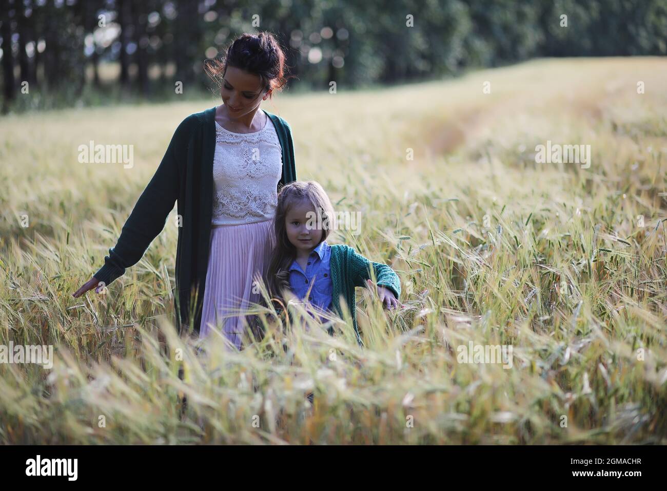 A young mother with her daughter on a walk in wheat fields Stock Photo ...