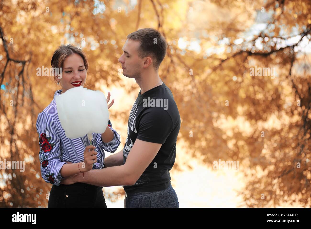 Beautiful young couple on a walk in the autumn park Stock Photo - Alamy