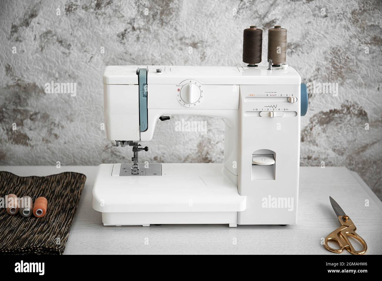 Sewing machine on table in tailor's Stock Photo Alamy