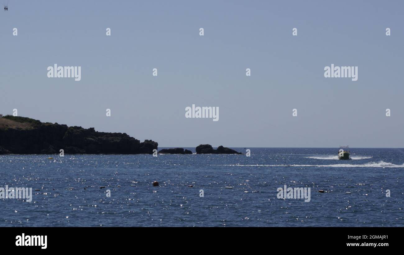 Blue sea and a sailing boat in the morning Stock Photo - Alamy