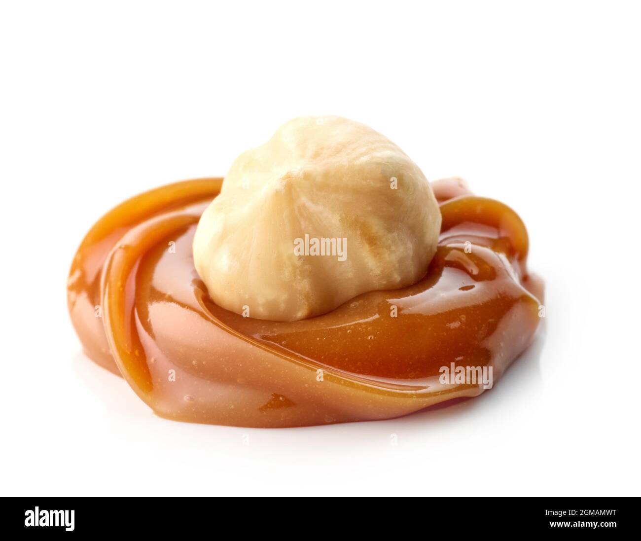 hazelnut in melted caramel macro isolated on white background Stock