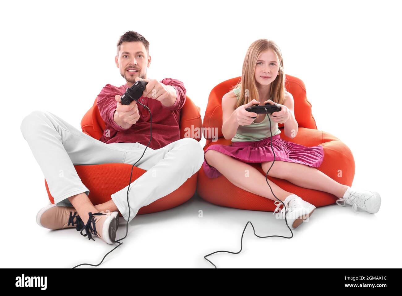 Teenage girl and her father playing video game on white background ...