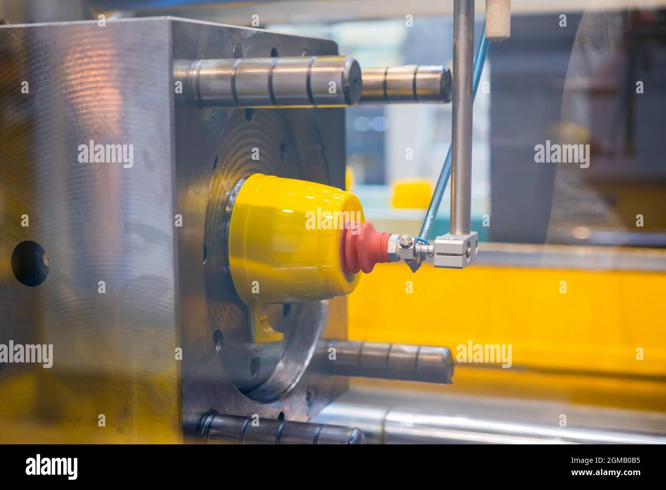 Injection molding machine during work: production of empty plastic cup ...
