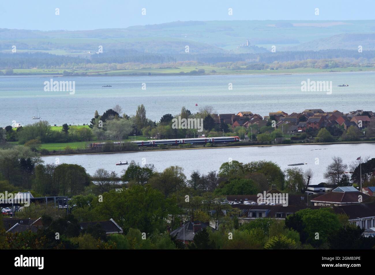 View over Poole Park lake and Poole Harbour, with the Purbeck hills and Corfe Castle in the background. Stock Photo