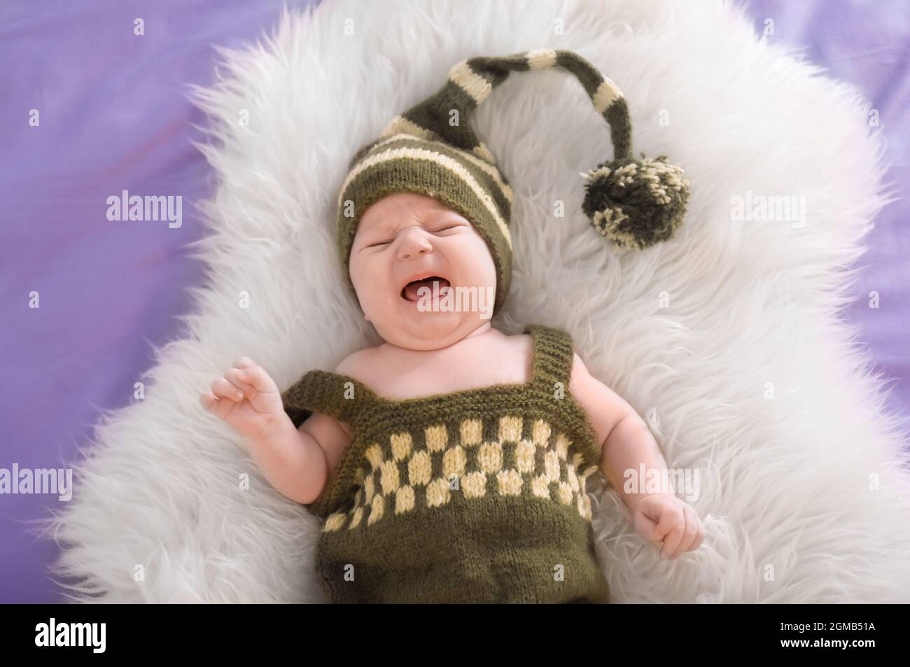 Cute little baby in elf costume lying on fur, top view Stock Photo Alamy