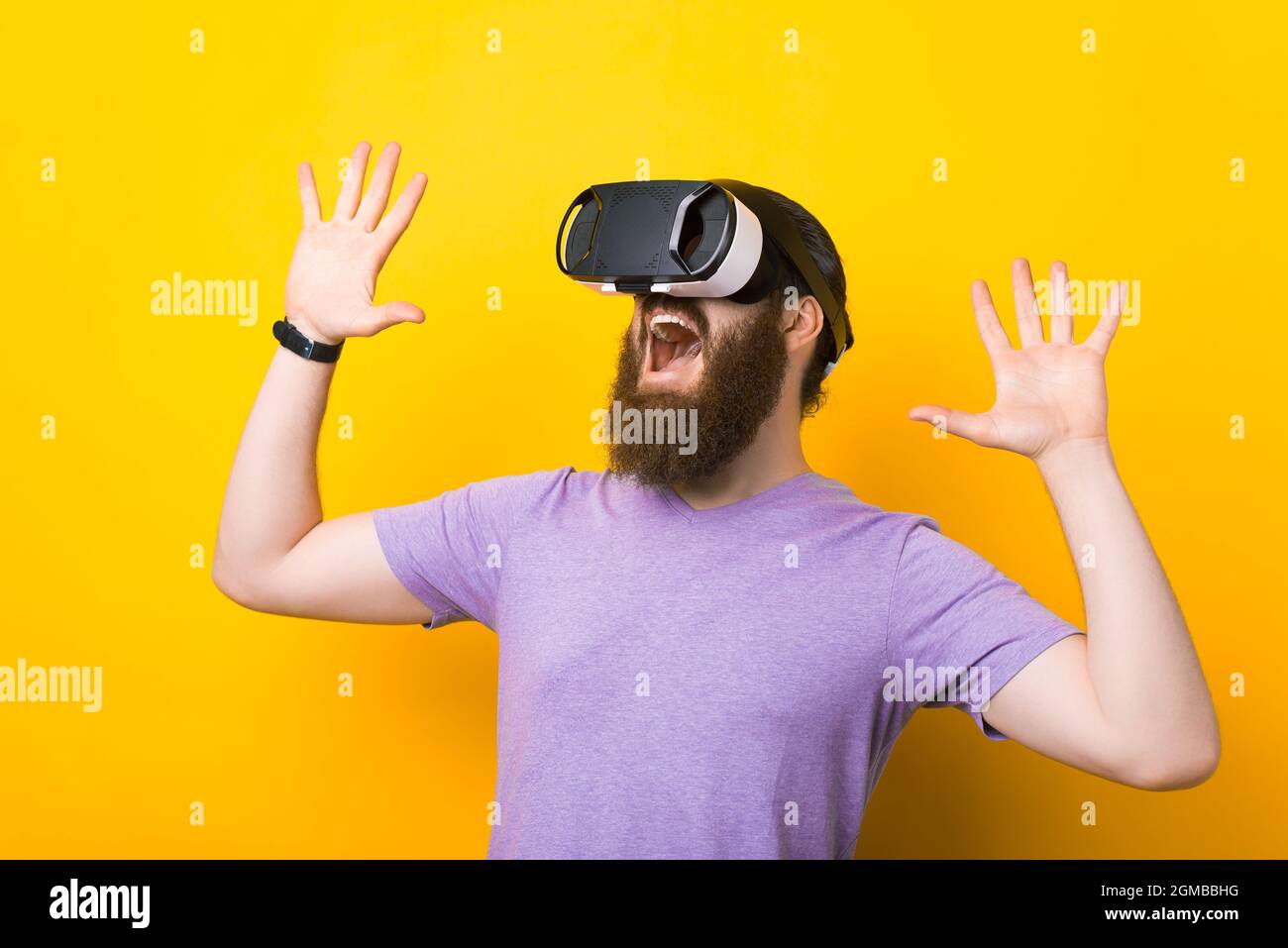 I cannot it. Excited bearded is wearing vr glasses over yellow Stock Photo - Alamy