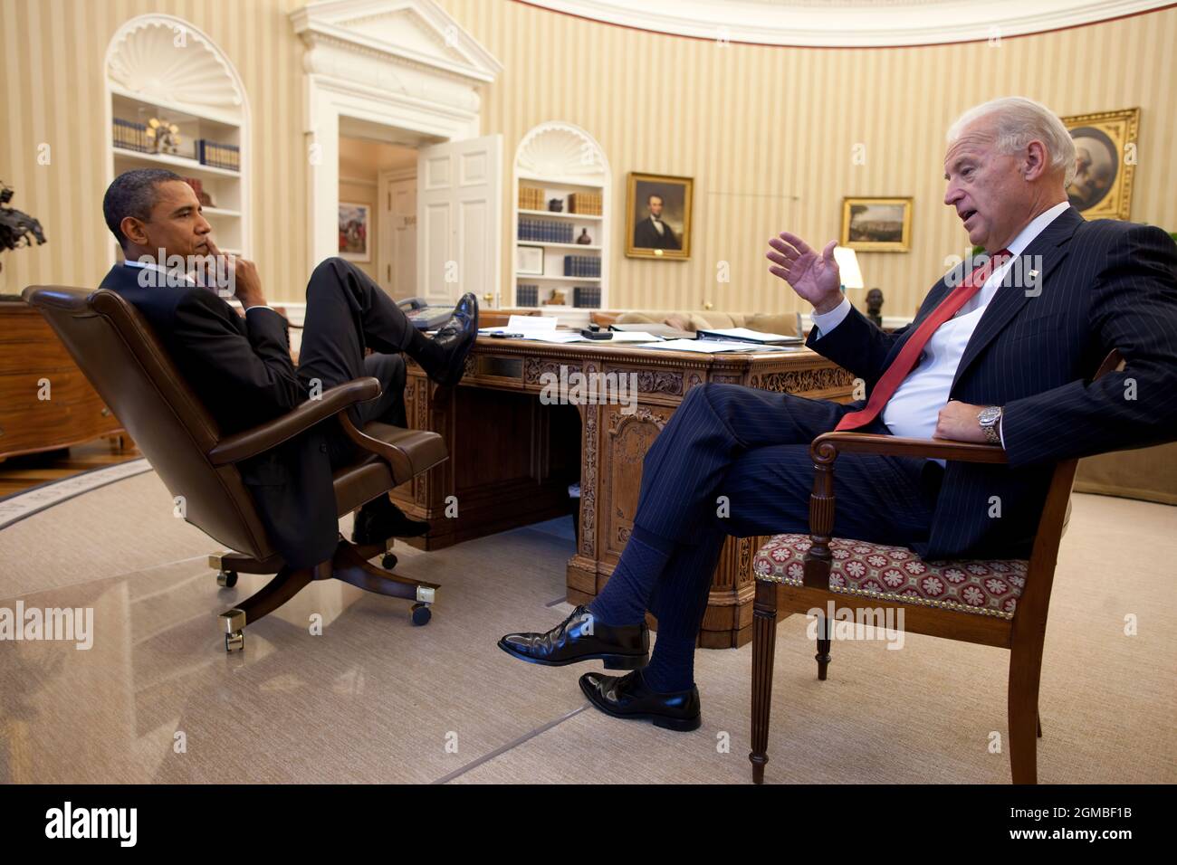 President Barack Obama talks with Vice President Joe Biden in the Oval Office, Nov. 3, 2010. (Official White House Photo by Pete Souza) This official White House photograph is being made available only for publication by news organizations and/or for personal use printing by the subject(s) of the photograph. The photograph may not be manipulated in any way and may not be used in commercial or political materials, advertisements, emails, products, promotions that in any way suggests approval or endorsement of the President, the First Family, or the White House. Stock Photo