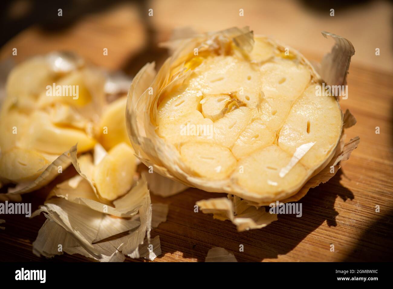 Half garlic on cutting board Stock Photo