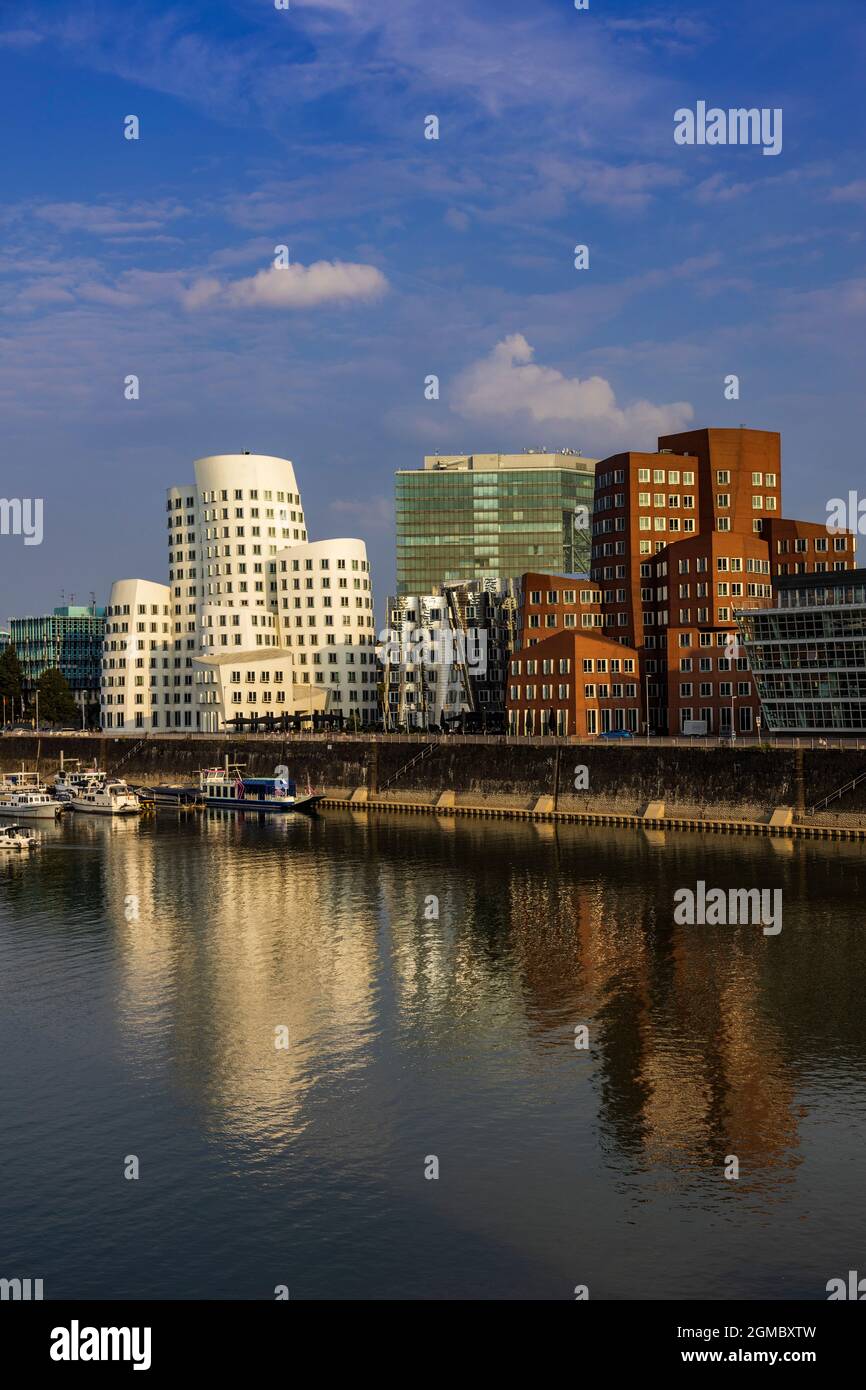 The 'Dancing Buildings' by Frank O Gehry in the evening light with copy space, at Neuer Zollhof, Medienhafen, Düsseldorf, Germany Stock Photo