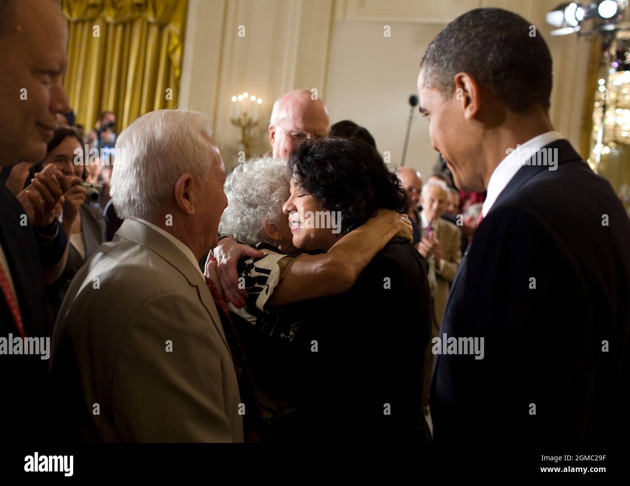 Aug. 12, 2009“The President had just paid tribute in an East Room reception to Supreme Court Justice Sonia Sotomayor, who had just been sworn-in. As they left the stage, Justice Sotomayor hugged her mother who was sitting in the front row.” (Official White House photo by Pete Souza)  This official White House photograph is being made available only for publication by news organizations and/or for personal use printing by the subject(s) of the photograph. The photograph may not be manipulated in any way and may not be used in commercial or political materials, advertisements, emails, products, Stock Photo