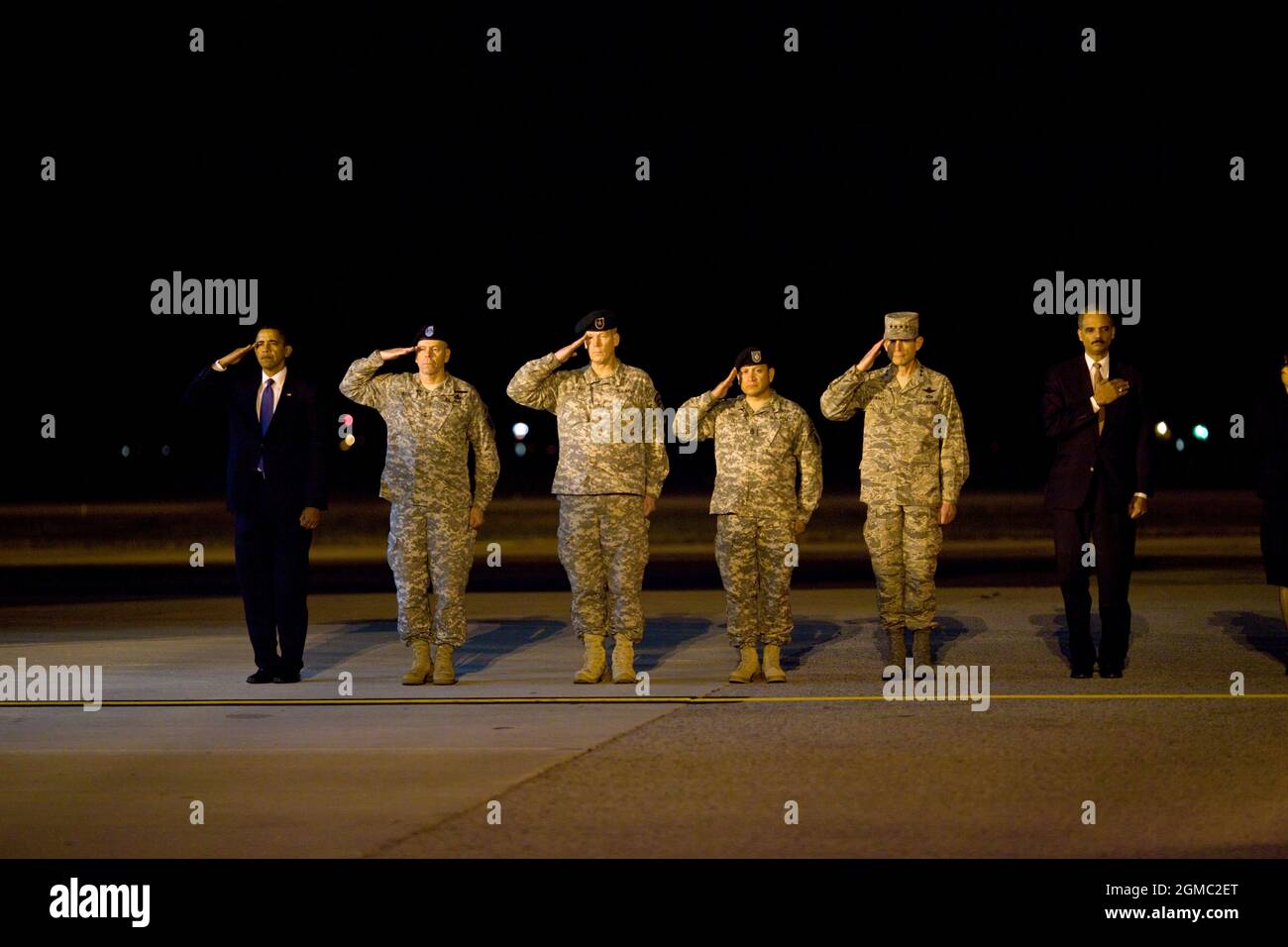 Oct. 29, 2009“This photo was taken about 4AM after the President made an unannounced trip to Dover Air Force Base to pay respects to fallen troops coming back from Afghanistan. After meeting privately with the families, the President walked alone up the ramp of the cargo plane carrying the 18 caskets, all draped in American flags. I could see the emotion on his face as he walked from casket to casket, leaving a Presidential coin on each. When he was done, he paused for a few minutes, head bowed in prayer. I heard him tell others later how that was the most difficult moment of his Presidency th Stock Photo