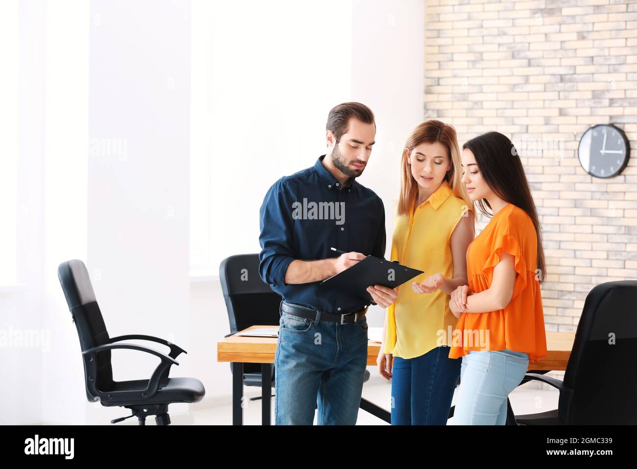 Real estate agent with trainee and client in office Stock Photo Alamy