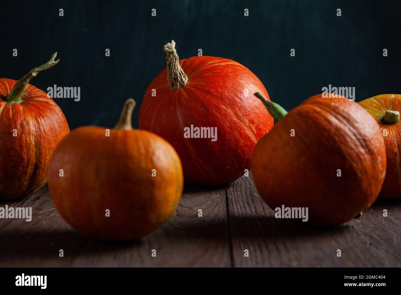 Pumpkins on wooden table with dark background. Stock Photo