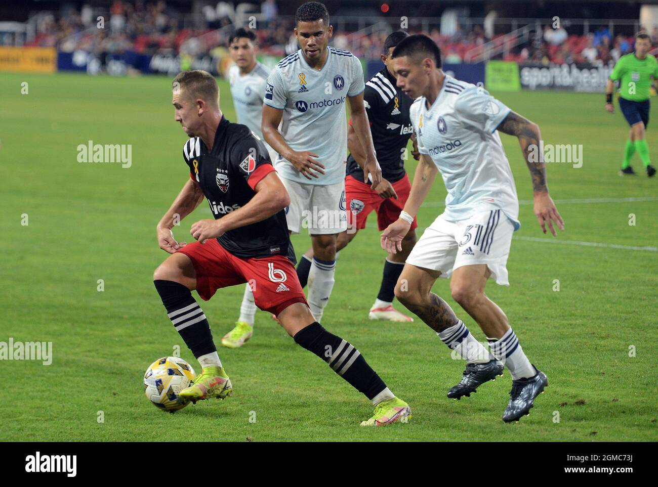 Washington, Dc, USA. 15th Sep, 2021. 20210915 - D.C. United midfielder RUSSELL CANOUSE (6) works possession of the ball away from Chicago Fire FC defender MIGUEL ANGEL NAVARRO (6) and Chicago Fire FC midfielder LEON FLACH (31) in the second half at Audi Field in Washington. (Credit Image: © Chuck Myers/ZUMA Press Wire) Stock Photo