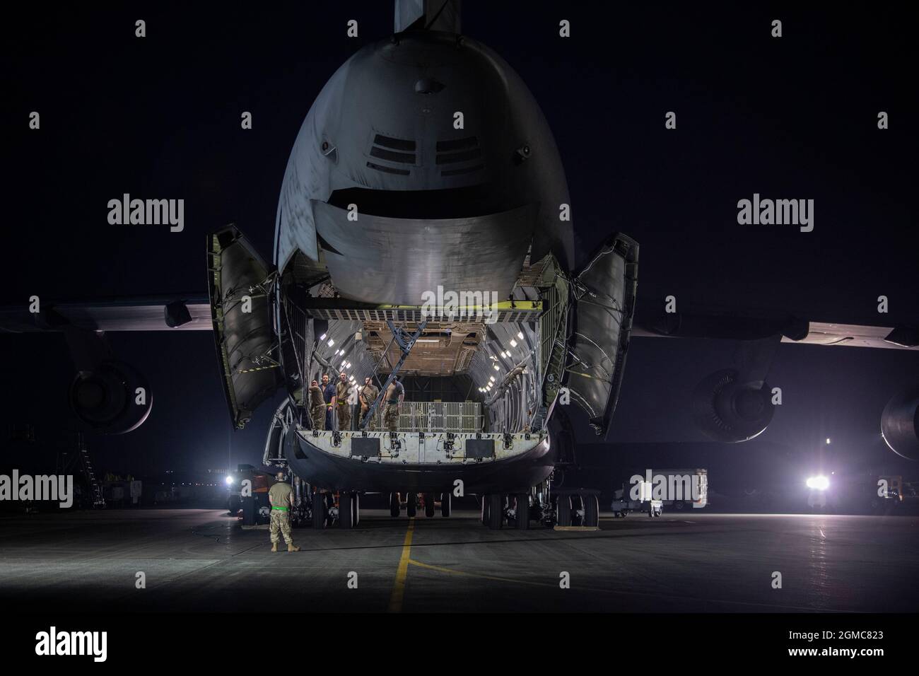 Airmen with the 730th Air Mobility Squadron open the loading bay of a C-5M Super Galaxy at Yokota Air Base, Japan, Sept. 14, 2021. The C-5 is the largest strategic transportation aircraft whose primary mission is to transport cargo and personnel for the Department of Defense. (U.S. Air Force photo by Senior Airman Brieana E. Bolfing) Stock Photo