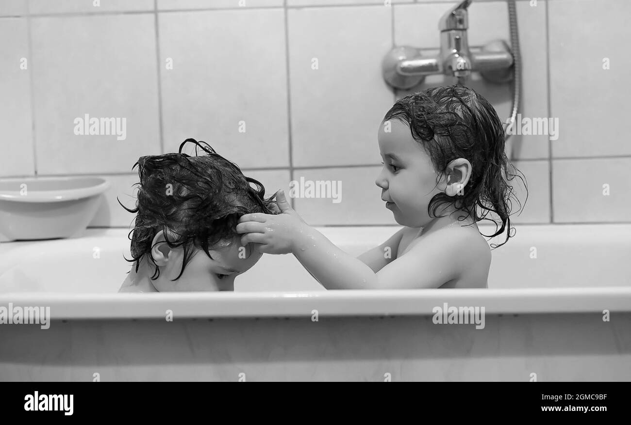 Young children take a bath. Children wash in bathroom. Brother and