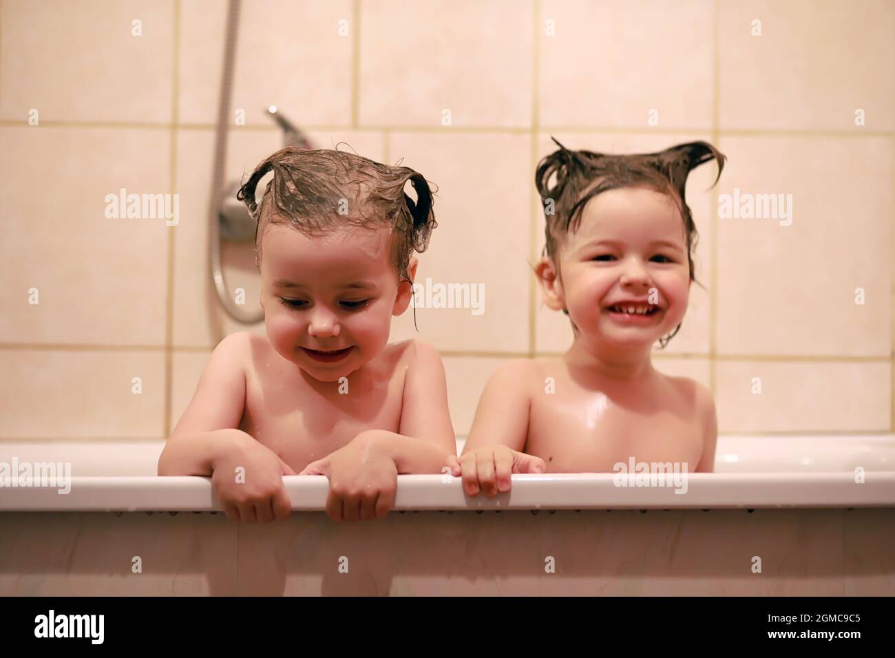 Young children take a bath. Children wash in bathroom. Brother and