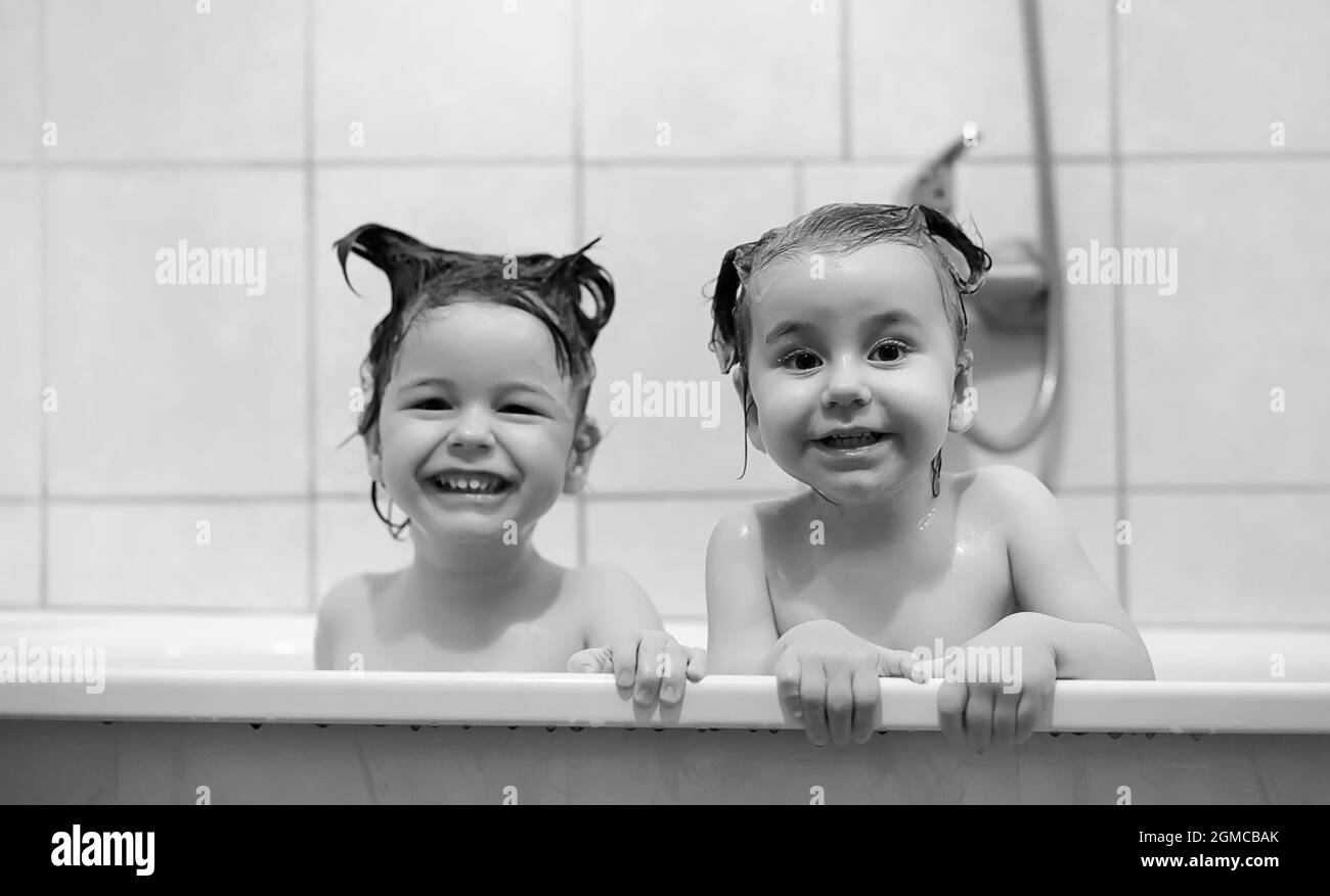 Young children take a bath. Children wash in bathroom. Brother and