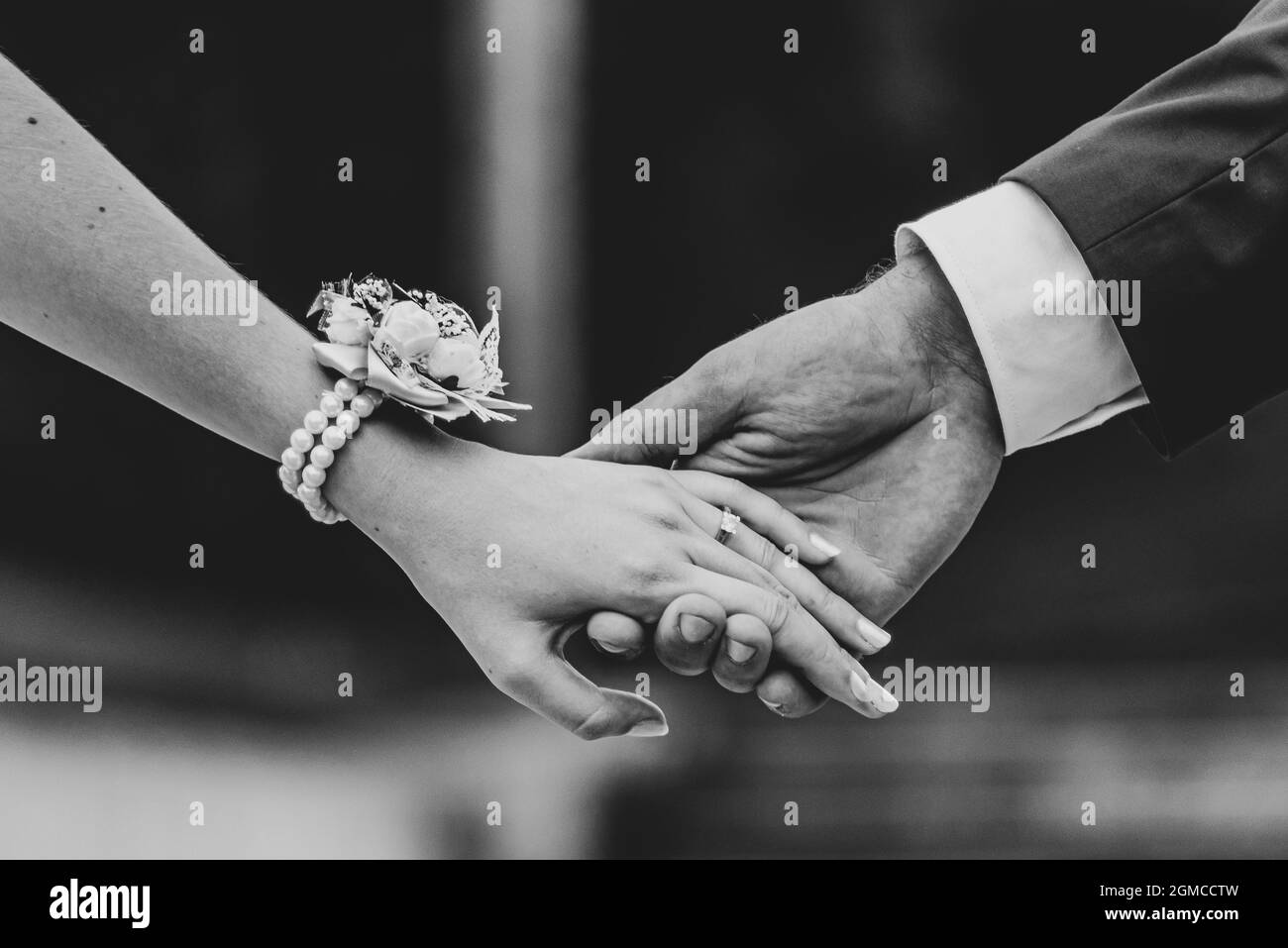bride and groom holding hands close up Stock Photo