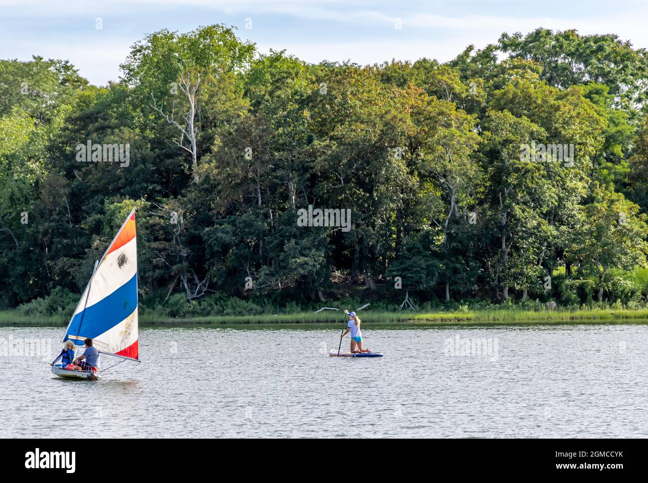 small sail boat and paddle boarder in North Haven, NY Stock Photo
