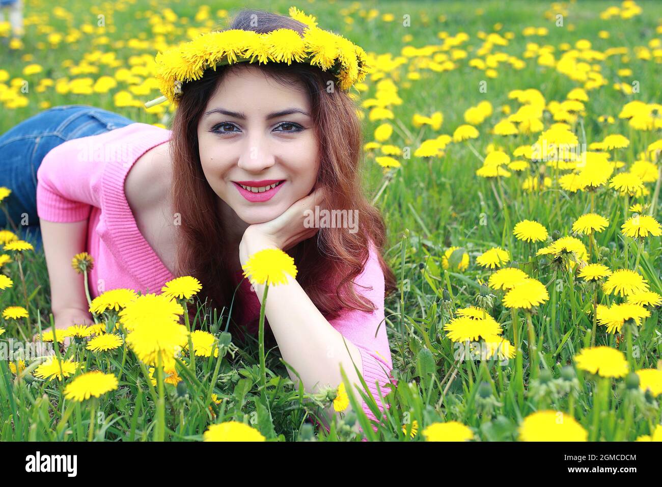 girl resting on a sunny day in a meadow of yellow dandelions Stock ...