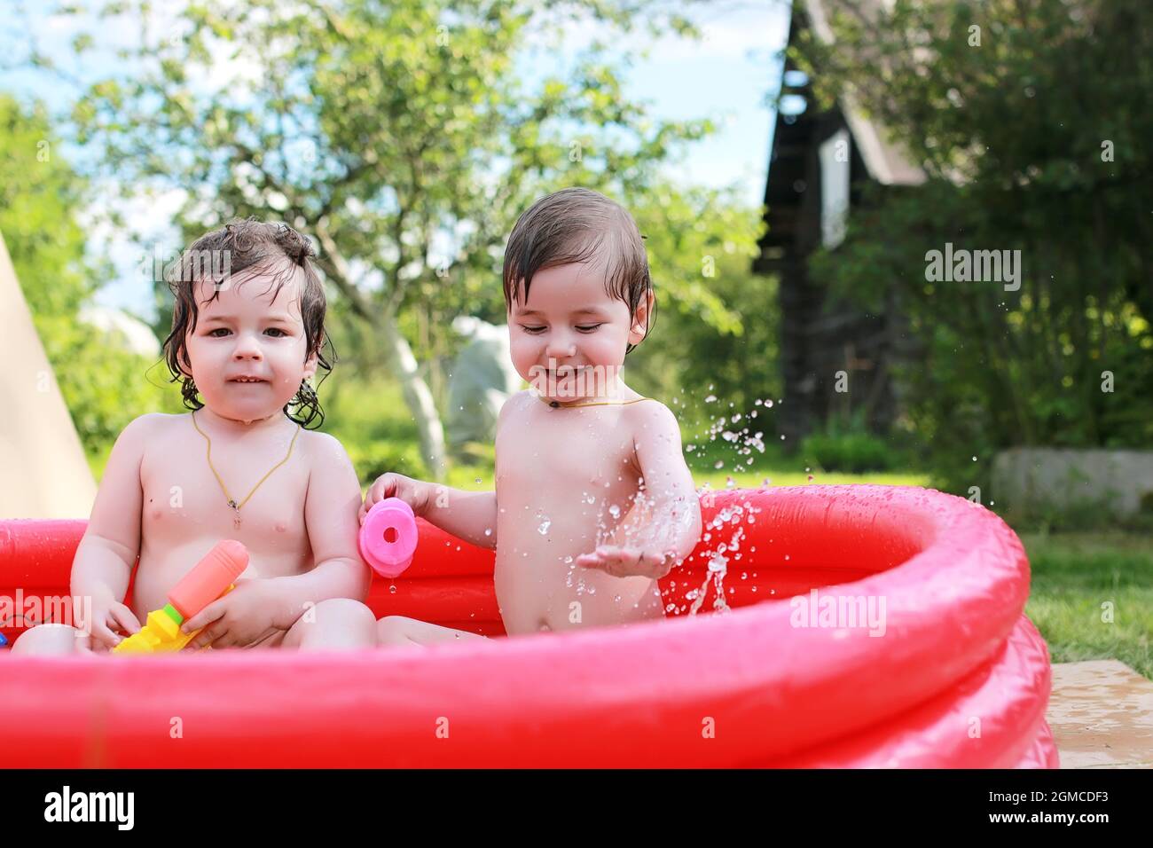 small children bathe in the pool inflatable on the street Stock Photo