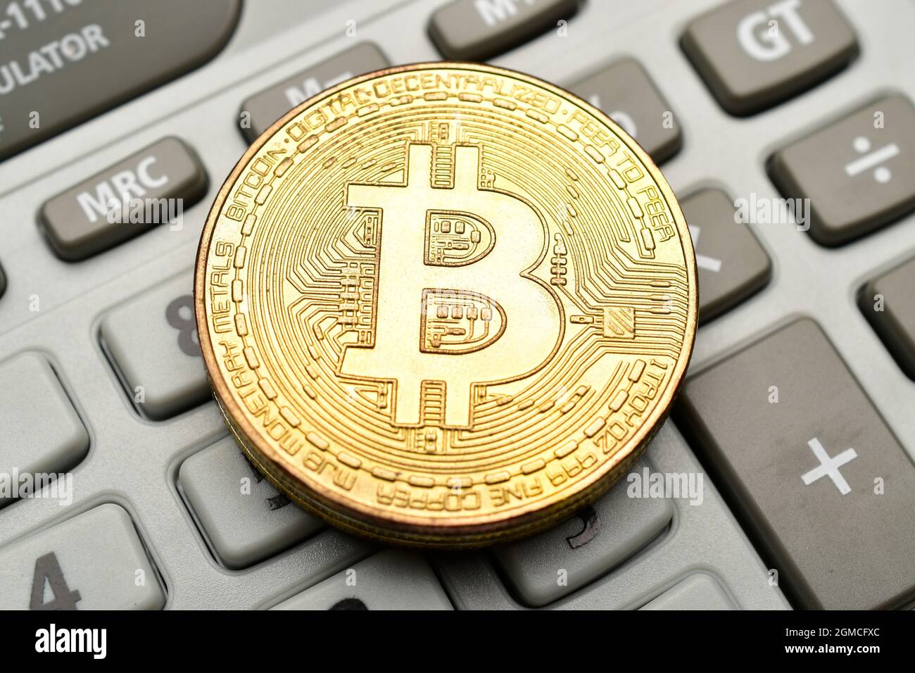 Bitcoin on top of calculator Stock Photo - Alamy