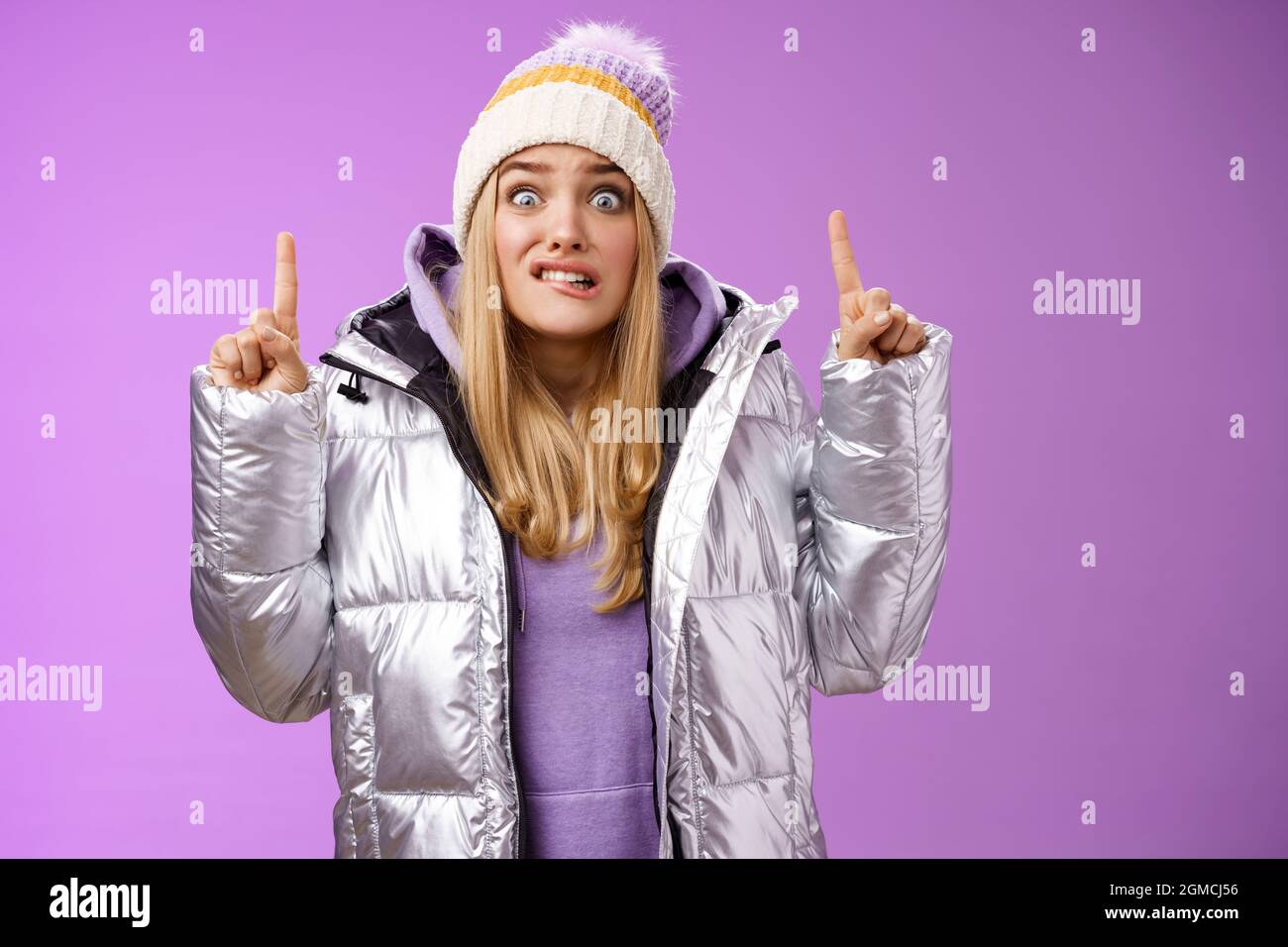 Scared unsure worried awkward young cute blond girl biting lip stooping ...