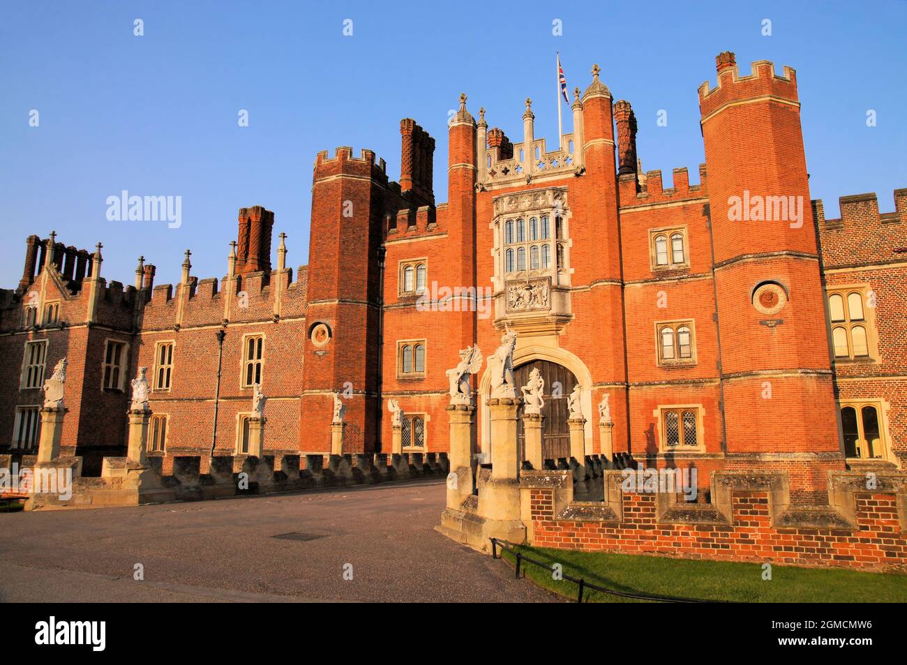 Great Gatehouse of Hampton Court Palace glowing red soon before sunset at Richmond, East Molesey, Surrey, England Stock Photo