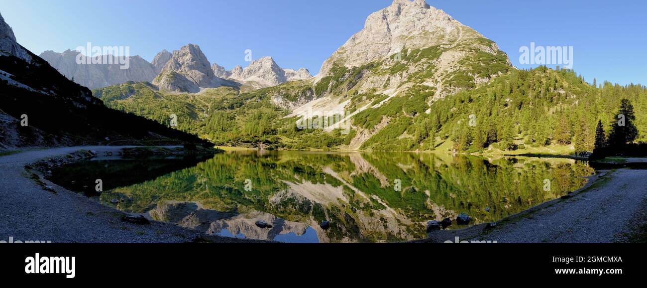 Panorama of mountains and near-perfect reflections in the lake in the ...