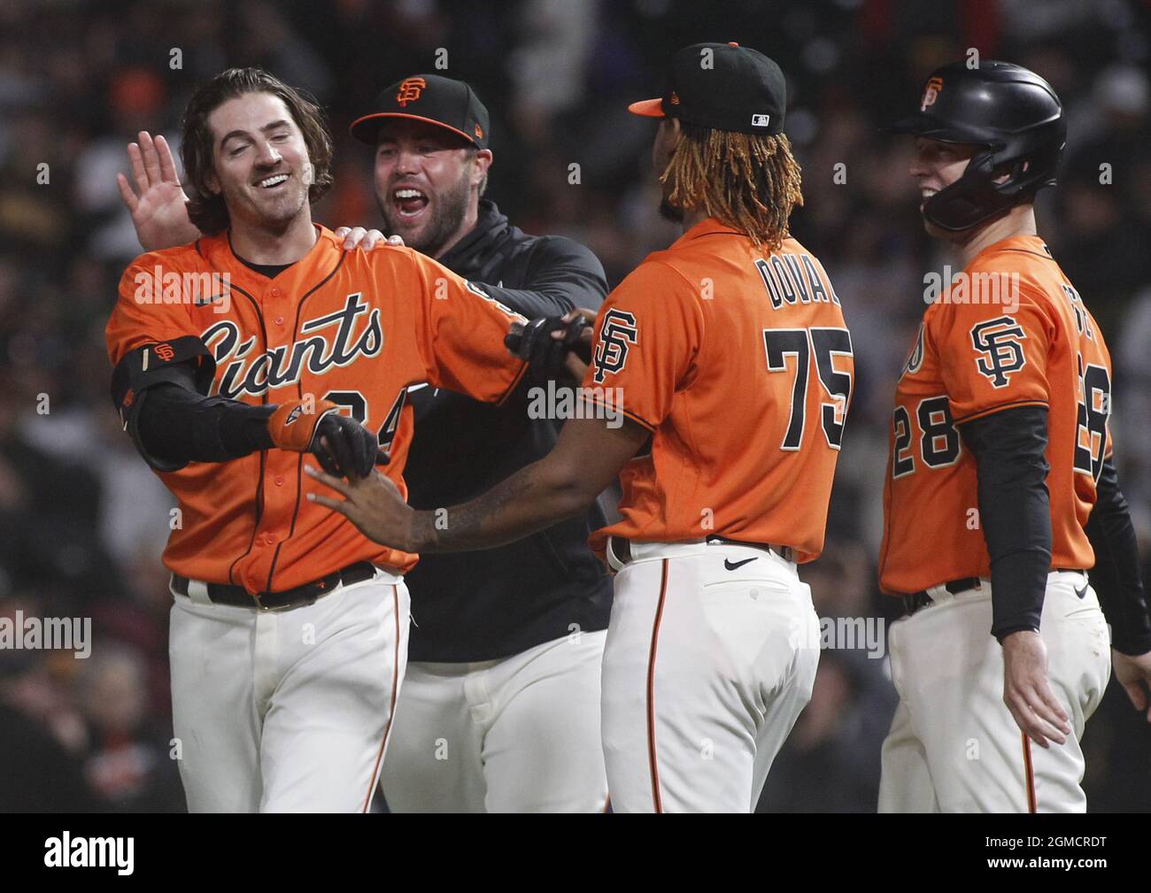 San Francisco, USA. 18th Sep, 2021. San Francisco Giants Kevin Gausman, left, celebrates with teamates after hitting a sacrifice fly ball, to score Brandon Crawford in the eleventh inning at Oracle Park on Friday, September 17, 2021 in San Francisco. Buster Posey is at far right and Camilo Doval (75) is center front. Photo by George Nikitin/UPI Credit: UPI/Alamy Live News Stock Photo
