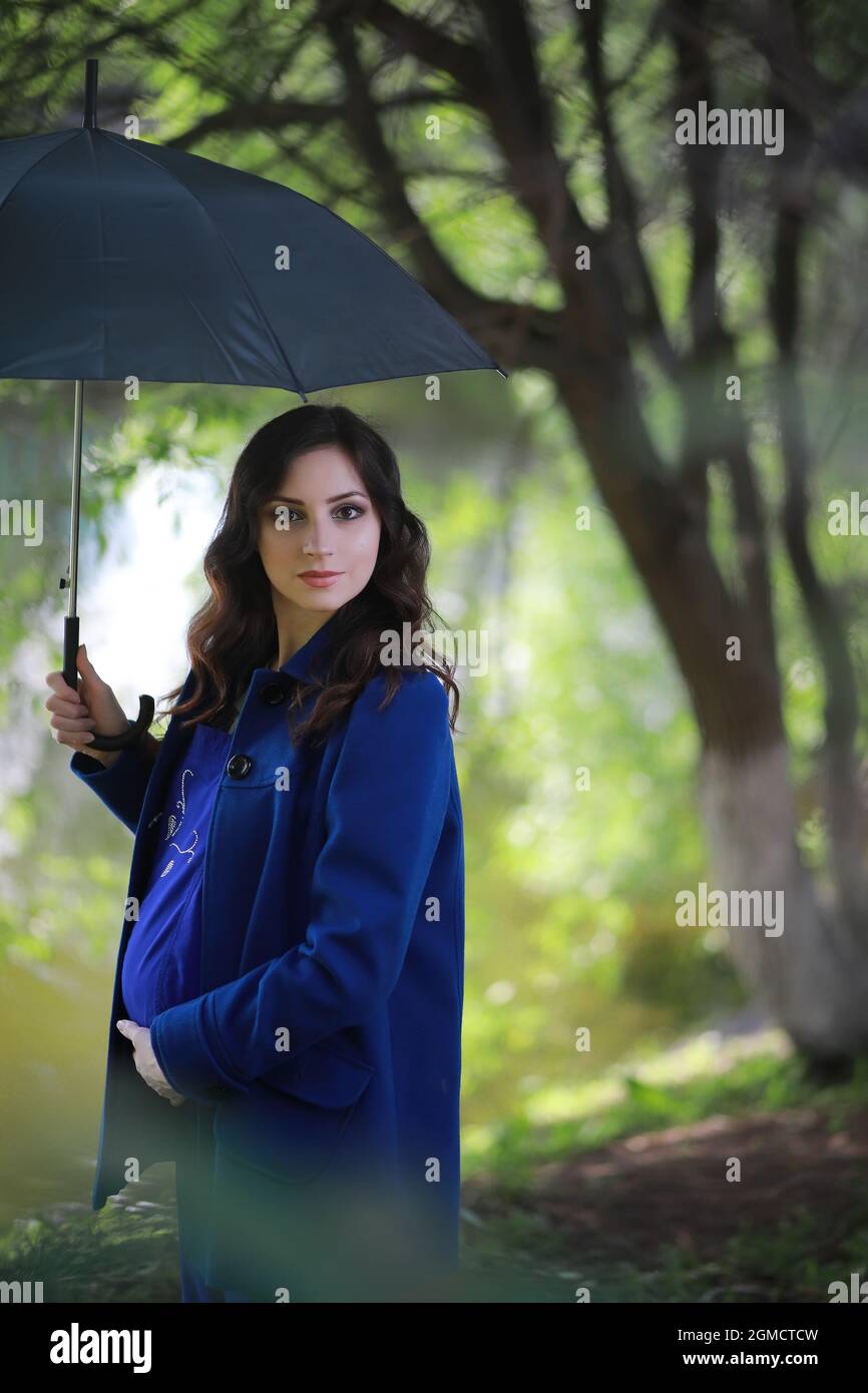 Pregnant woman on a walk in the park Stock Photo - Alamy