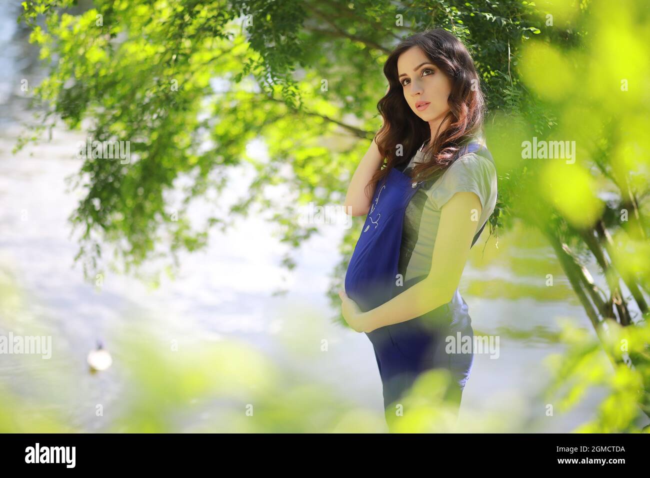 Pregnant woman on a walk in the park Stock Photo - Alamy