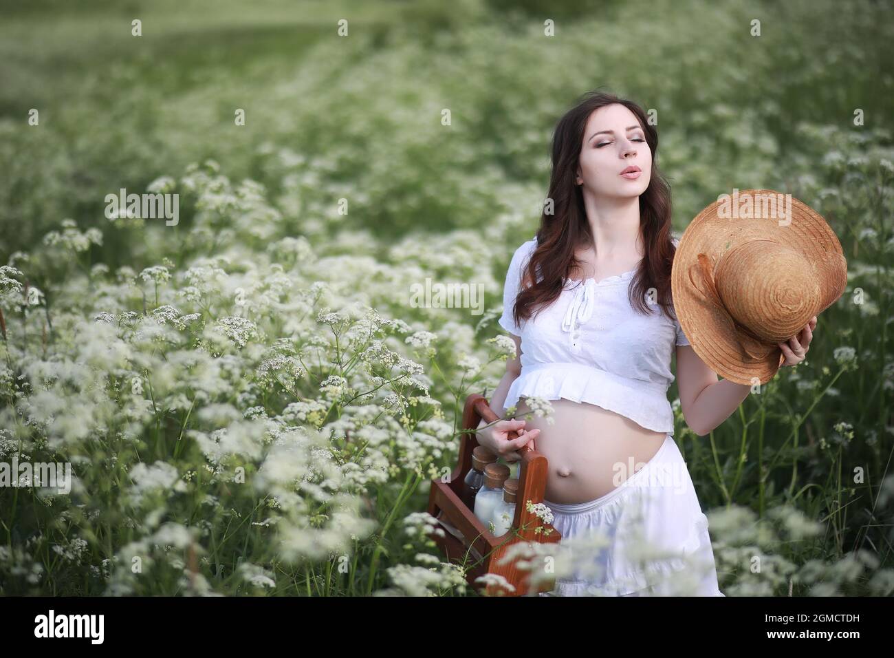 Pregnant woman in nature for a walk summer Stock Photo - Alamy