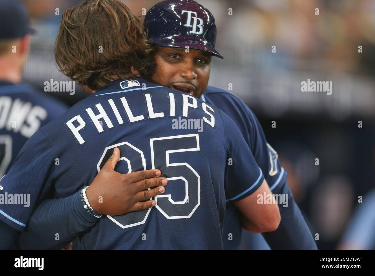 St. Petersburg, FL. USA;  Tampa Bay Rays third base coach Ray Linares hugs right fielder Brett Phillips (35) after his walk off homer in the bottom of Stock Photo