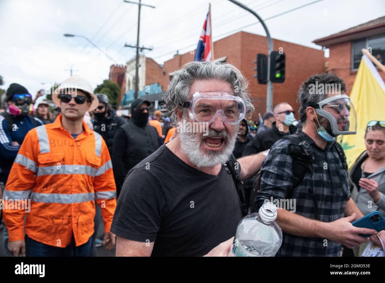 Melbourne, Australia. 18th September 2021. Anti-lockdown protesters with protective face gear yell at police, asking the officers to join them. Credit: Jay Kogler/Alamy Live News Stock Photo